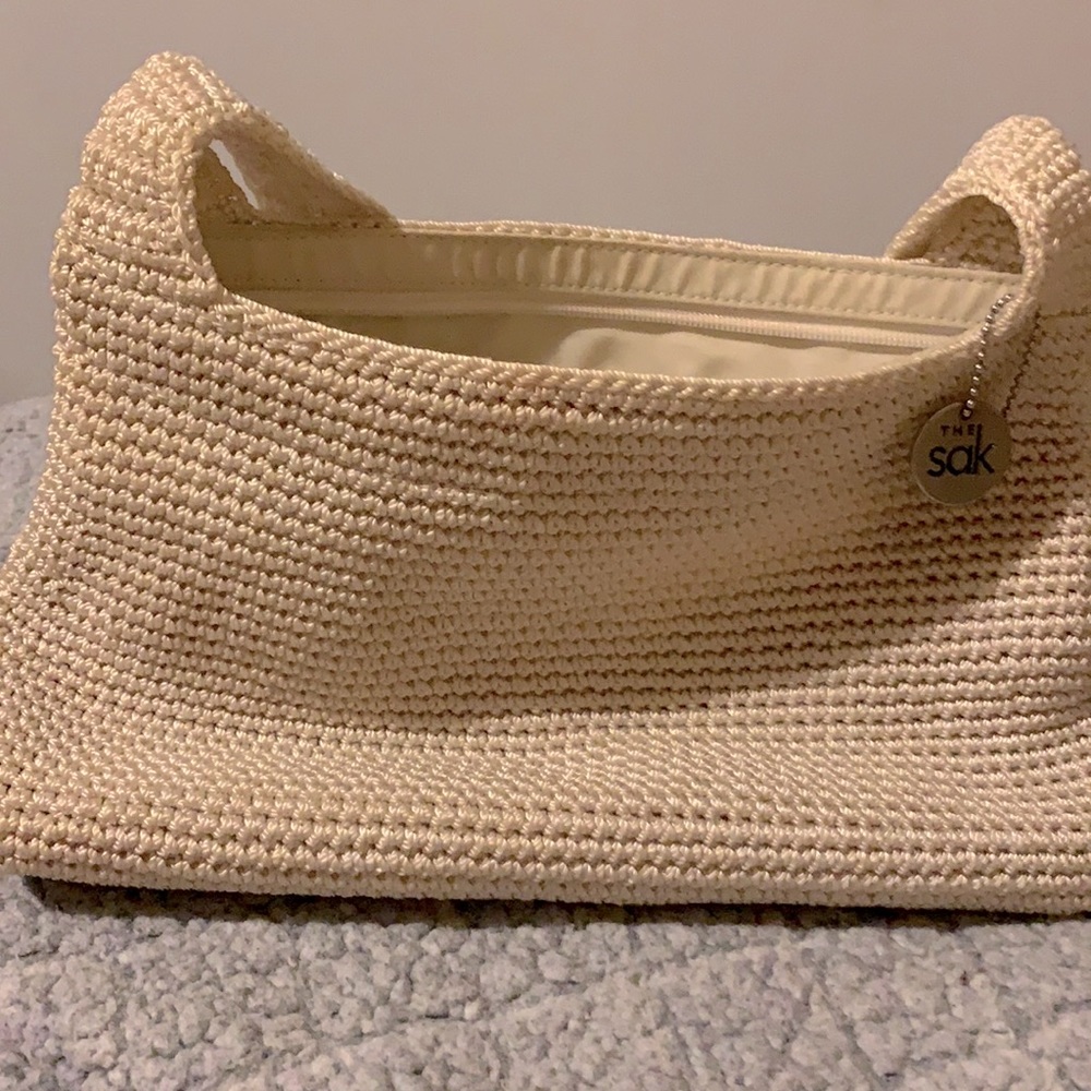 Cream or egg shell colored Sakroots purse